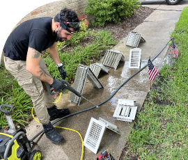 Clean & Green Air team cleaning and sanitizing the air vents.